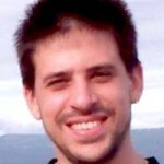 A uniform bound for the Lagrange polynomials of Leja points for the unit disk and applications in multivariate Lagrange interpolation